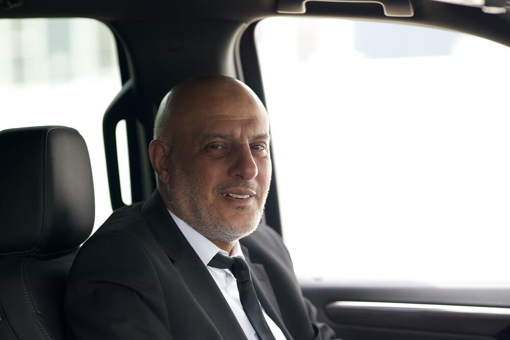 Smiling Fast Black Car chauffeur behind the wheel